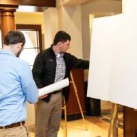 Participants setting up their posters at the 2023 Graduate Showcase.